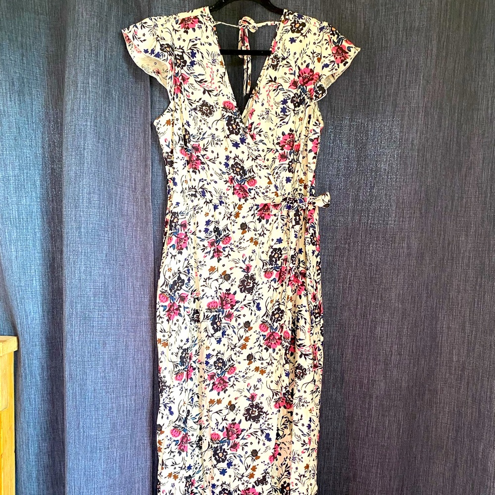 Floral maxi length dress with flutter sleeves.